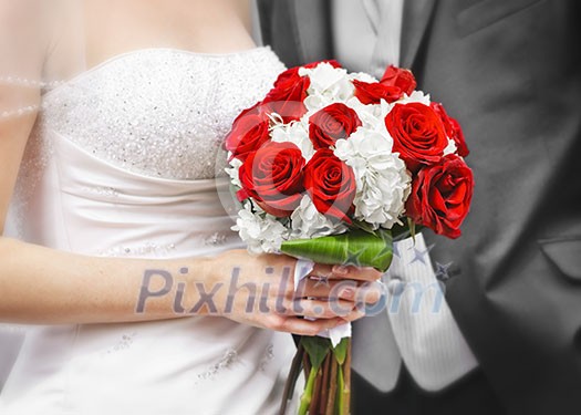 Bride and groom holding bridal bouquet close up Bride and groom holding bridal bouquet close up