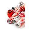 Rolls of Christmas wrapping paper with ribbons, bows and scissors