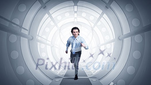 Young businessman running in futuristically designed tunnel Young businessman running in futuristically designed tunnel