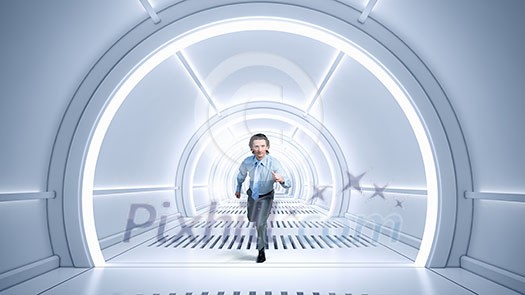 Young businessman running in futuristically designed tunnel Young businessman running in futuristically designed tunnel