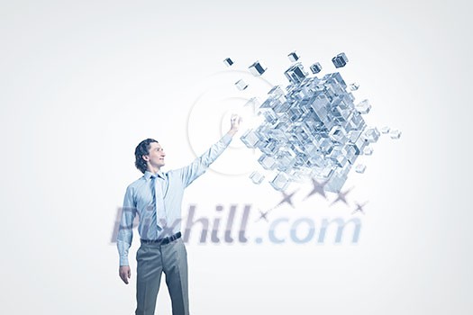 Businessman reaching hand to touch digital cube figure Businessman reaching hand to touch digital cube figure