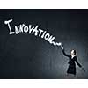 Businesswoman in darkness drawing word promotion with flashlight