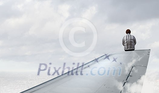 Middle aged stout woman sitting on edge of aairplane wing Middle aged stout woman sitting on edge of aairplane wing