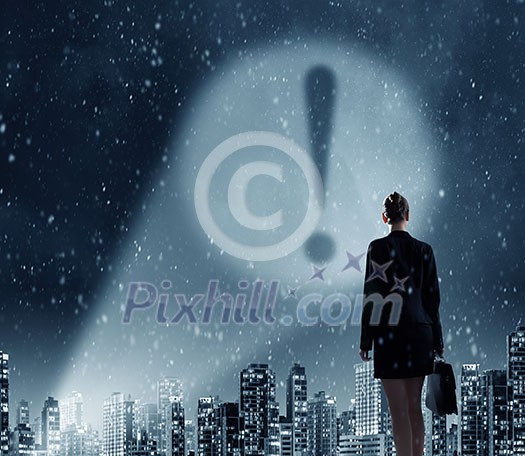 Businesswoman standing with back and exclamation mark in spotlight