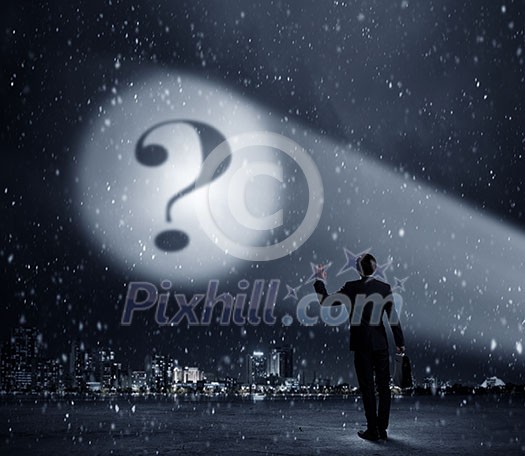 Businessman standing with back and looking at question mark concept Businessman standing with back and looking at question mark concept