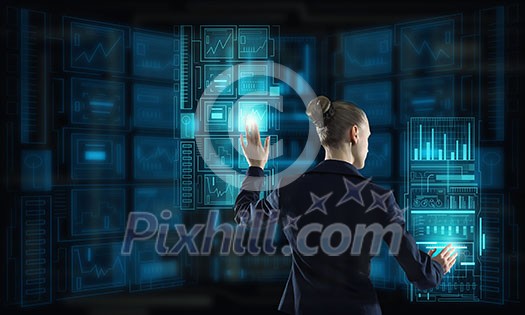 Rear view of businesswoman working with virtual panel interface Rear view of businesswoman working with virtual panel interface