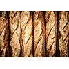 Fresh artisan baguette bread loaves in a row