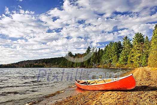 Red canoe on beach at Lake of Two Rivers, Ontario, Canada Red canoe on beach at Lake of Two Rivers, Ontario, Canada