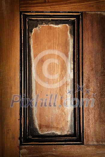 Panel in antique wooden door as vintage frame or rustic background Panel in antique wooden door as vintage frame or rustic background