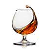 Splash of cognac in glass isolated on white background