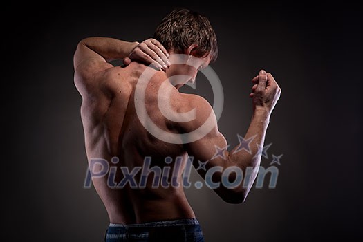 Muscular naked man from back on black Muscular naked man from back on black