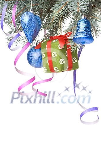 Christmas balls, gift and decoration on fir tree branch isolated on white