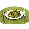 Plate of green brussels sprouts with knife and fork