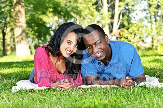 Young romantic couple enjoying summer day in park