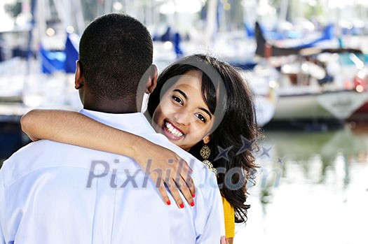 Beautiful young woman hugging boyfriend standing at harbor Beautiful young woman hugging boyfriend standing at harbor