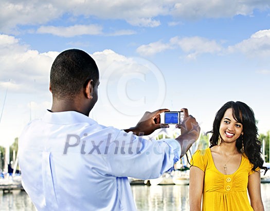 Beautiful woman posing for vacation photo at harbor with sailboats Beautiful woman posing for vacation photo at harbor with sailboats