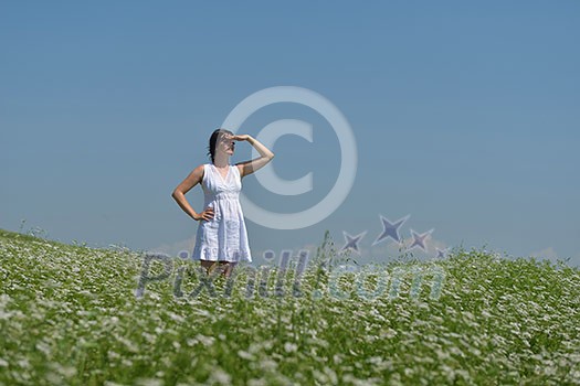 Young happy woman in green field with blue sky in background Young happy woman in green field with blue sky in background