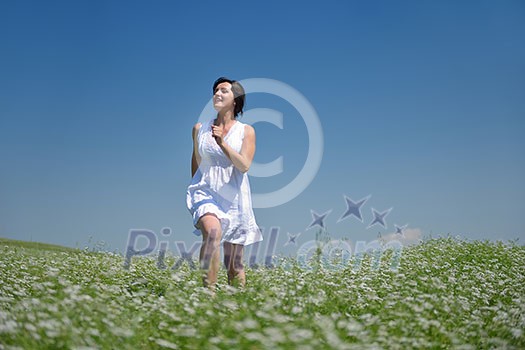 Young happy woman in green field with blue sky in background Young happy woman in green field with blue sky in background