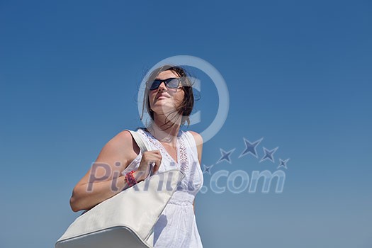 happy young tourist woman have fun while traveling araund city with blue sky and sea in background
