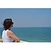 happy young tourist woman have fun while traveling araund city with blue sky and sea in background