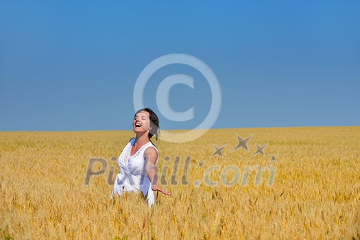Young woman standing jumping and running on a wheat field with blue sky the background at summer day representing healthy life and agriculture concept Young woman standing jumping and running on a wheat field with blue sky the background at summer day representing healthy life and agriculture concept