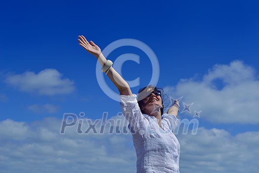 healthy Happy young woman with spreading arms, blue sky with clouds in background - copyspace healthy Happy young woman with spreading arms, blue sky with clouds in background - copyspace
