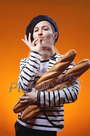 woman holding baguettes and shows that taste is delicious woman holding baguettes and shows that taste is delicious