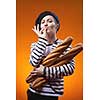 woman holding baguettes and shows that taste is delicious