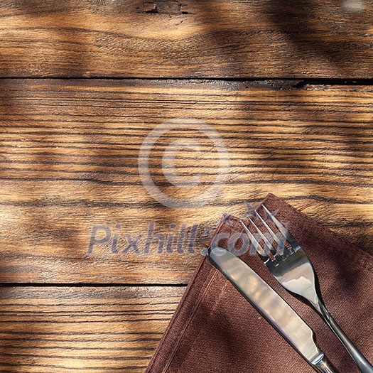Empty board with fork and knife on wooden table. Top view Empty board with fork and knife on wooden table. Top view