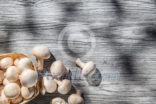 Mushrooms on wooden table, top view image