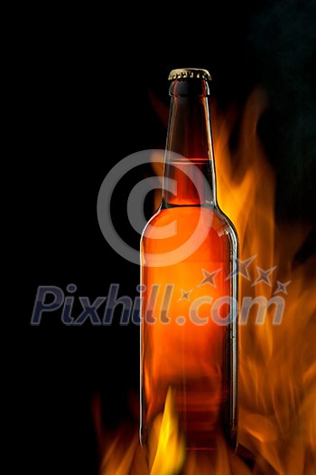 Beer bottle in fire on black Beer bottle in fire on black