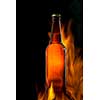 Beer bottle in fire on black