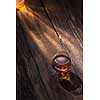 Cognac in glass on the wooden surface