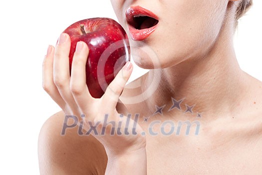 Young woman biting red apple isolated on white