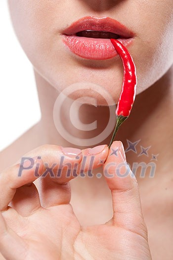 Young woman with chili pepper isolated on white Young woman with chili pepper isolated on white