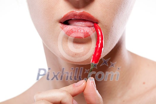 Young woman with chili pepper isolated on white Young woman with chili pepper isolated on white