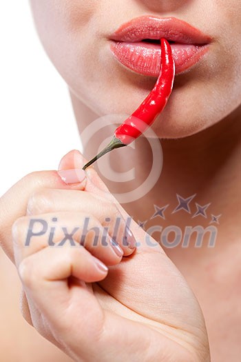 Young woman with chili pepper isolated on white Young woman with chili pepper isolated on white