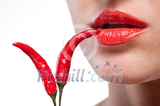 Young woman with chili pepper isolated on white Young woman with chili pepper isolated on white