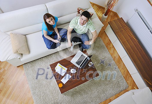 young couple at home with  modern livingroom indoor working on laptop on house finance and planing