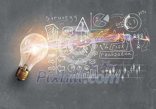 Glass glowing light bulb and business sketched ideas Glass glowing light bulb and business sketched ideas