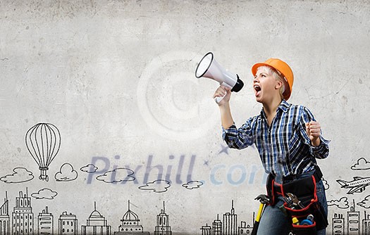 Young emotional woman builder screaming in megaphone Young emotional woman builder screaming in megaphone