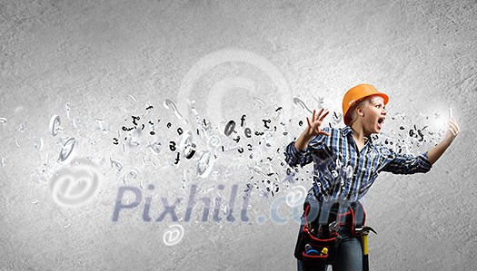 Young emotional woman mechanic screaming in mobile phone Young emotional woman mechanic screaming in mobile phone