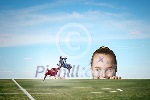 Little girl looking at two football players Little girl looking at two football players