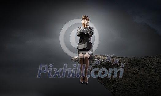 Young businesswoman covering her eyes with hands Young businesswoman covering her eyes with hands