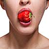 Young woman biting strawberry isolated on white