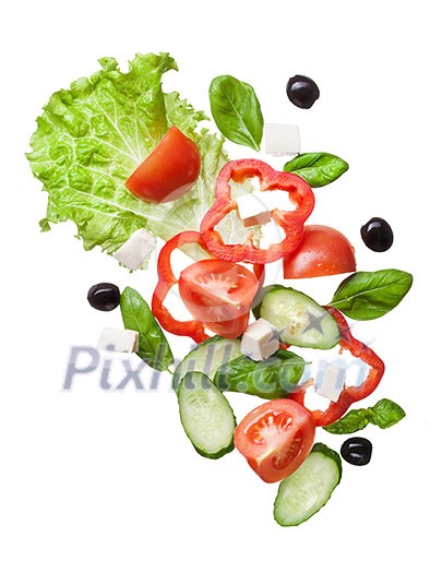 flying salad isolated in white - red tomatoes, pepper, cheese, basil, cucumber and olives
