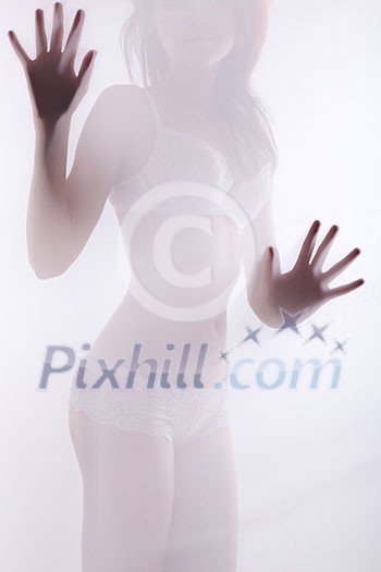 Diffuse sexy woman shape behind white cloth