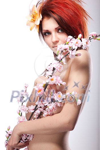 Portrait of beautiful naked woman with spring flower in hair on white Portrait of beautiful naked woman with spring flower in hair on white