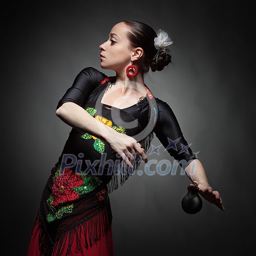 young woman dancing flamenco with castanets on black young woman dancing flamenco with castanets on black