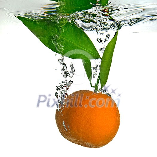 tangerine dropped into water with bubbles on white tangerine dropped into water with bubbles on white